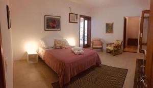 A bed or beds in a room at Picollo Bambino Suítes Ilhabela