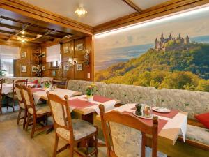 a restaurant with a painting of a castle on the wall at Hotel Garni in der Breite in Albstadt