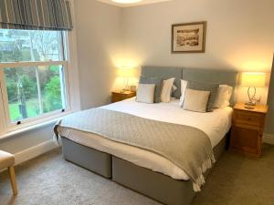 a bedroom with a large bed and a window at The Claremont Hotel-Adult Only in Polperro