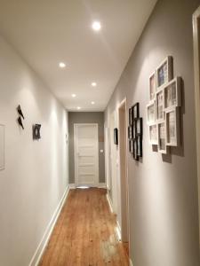 a hallway with photographs and pictures on the walls at Casa do Jardim Escola in Tomar