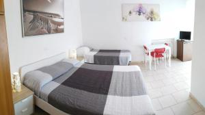 A bed or beds in a room at Residence Hotel Vittoria