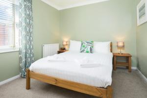 a bedroom with a large white bed and a window at Central Portland Street with Free Parking in Brighton & Hove