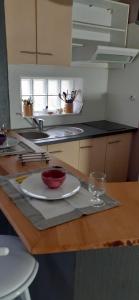 a kitchen with a plate and a glass on a counter at Jolie T2 au coeur du bourg in Carnac