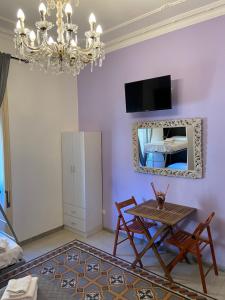 a dining room with a table and a mirror at Sweet Sleep Vatican in Rome