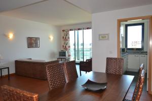 a dining room with a wooden table and chairs at Residence Golf Club by Garvetur in Vilamoura