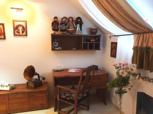 a room with a desk and a tv on a wall at Penzion a Restauracia Toldi in Galanta