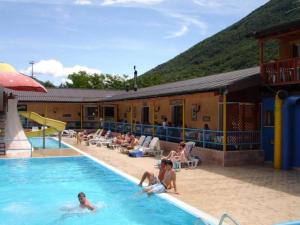 a group of people in the swimming pool at a hotel at Mylooking vacanze Porlezza in Porlezza