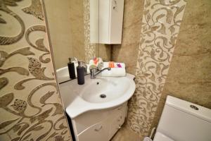 a bathroom with a sink and a mirror at GM 15 Apartments in Sibiu +55 photos