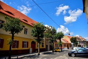 a street in a town with trees and buildings at GM 15 Apartments in Sibiu