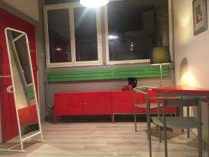 a room with red and green cabinets and a table at au parc Montsouris in Paris