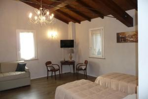 a living room with a bed and a table at Antico Podere Emilia in Reggio Emilia