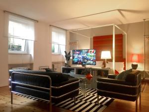 a living room with two couches and a large mirror at Berlin Style Apartments - Schönholzer Straße in Berlin