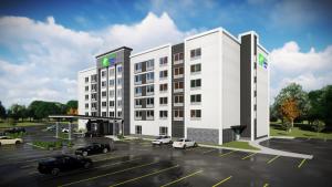 a rendering of a building with cars parked in a parking lot at Holiday Inn Express & Suites - Aurora, an IHG Hotel in Aurora