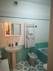 a bathroom with a sink and a toilet at Dimora Tipica Appartamento in Sestri Levante