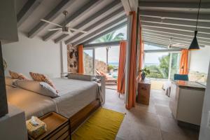a bedroom with a bed and a view of the ocean at Anjali Casa Divina in Sayulita