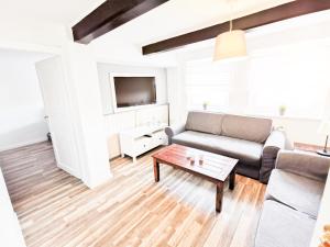 a living room with a couch and a coffee table at Ferienwohnung Mila in Grevenkop