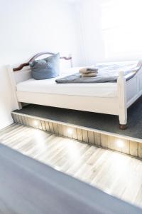 a bed with lights on the floor in a room at Ferienwohnung Mila in Grevenkop