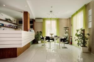 a dining room with a table and some plants at Hotel 33 Baroni in Gallipoli