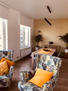 a living room with two couches and a table at Historic Centre Duplex - Ghent Belfry & St Nicholas Church View in Ghent