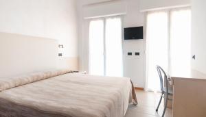 A bed or beds in a room at Hotel Aria di Mare - Bed & Brunch in centro a Riccione