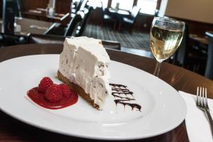 a piece of cake on a white plate with strawberries at Tuckers Inn in Invergordon