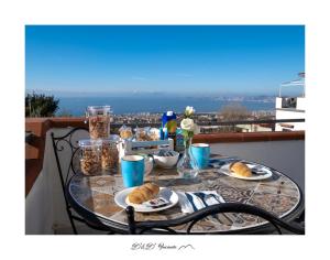 a table with plates of food on a balcony at B&B Incanto in Ercolano