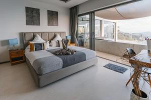 a bedroom with a large bed and a large window at Paradise Villa Eden in Bophut