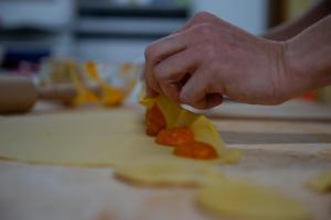 a person cutting up carrots on a cutting board at Agriturismo Mocine in Asciano