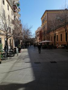 a city street with people walking down the street at Pigneto7 in Rome