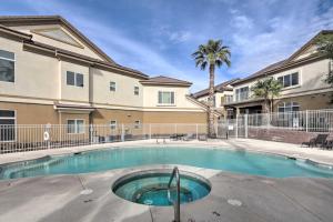 a swimming pool in front of a building at Desert Condo with Pool about 3 Miles to Colorado River! in Bullhead City