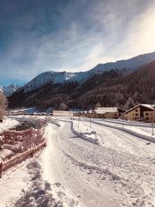 a snow covered road with mountains in the background at Studio in Klosters in Klosters