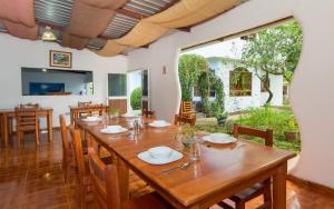 a dining room with a large wooden table and chairs at Hotel Twin Galápagos in Puerto Ayora