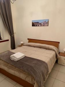 een slaapkamer met een groot bed met een bruin hoofdeinde bij La Piccola Reggia in Napels