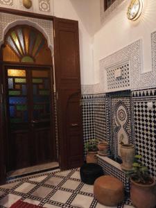 a room with a door and a floor with tiles at Dar atlas in Fès