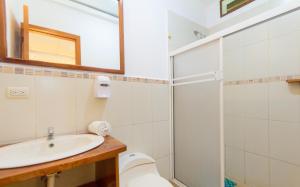 a bathroom with a sink and a shower and a toilet at Hotel Twin Galápagos in Puerto Ayora +40 photos
