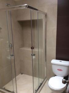 a shower stall in a bathroom with a toilet at Suite Hermano Miguel in Cuenca