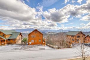 een groot houten huis met bergen op de achtergrond bij Big Sky in Pigeon Forge