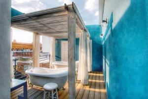 a bathroom with a bath tub on a deck at La Casa del Atrio in Querétaro