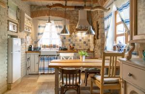 eine Küche mit einem Holztisch und Stühlen in der Unterkunft Koloska House in Balatonfüred