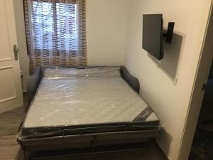 a small bed in a room with a window at Fuerteventura Luxury sun in Morro del Jable