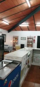 a kitchen with white counter tops in a room at ALBERGUE TURÍSTICO DE CORNALVO in Trujillanos +5 photos