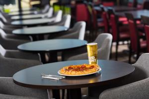 a pizza on a table with a drink on it at Holiday Inn Express Bath, an IHG Hotel in Bath