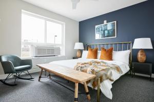 a bedroom with a bed and a desk and a chair at Sonder Osage in Denver