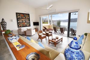 a living room with a couch and a table at 1031 - Villas Carey Condo in Santa Maria Huatulco