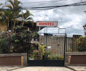 a wrought iron gate with a sign for a hostel at AeroHostel 418 in Rio de Janeiro