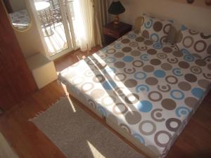 a bed with polka dot sheets and pillows in a bedroom at Villa Old Town in Ohrid