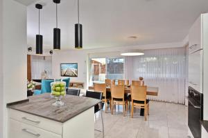 a kitchen and dining room with a table and chairs at וילה דולב in Eilat