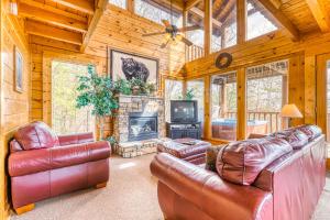 a living room with leather furniture and a fireplace at Just the Two of Us in Pigeon Forge