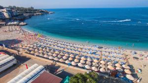 an overhead view of a beach with umbrellas and the ocean at Sunset Hotel & Beach in Dobra Voda