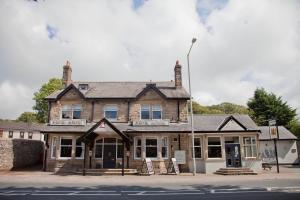 an old building on the corner of a street at The Royal Hotel in Bolton le Sands